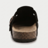 The Amber Clog hervelora (4) "Front Hero: Olive suede buckle-strap mule clog with cork-effect sole, side profile on plain background Beach Lifestyle: Woman wearing tan suede buckle mules walking on sand, open-back clog silhouette visible Detail Shot: Close-up of adjustable gold buckle strap and molded arch footbed on suede mule clog"